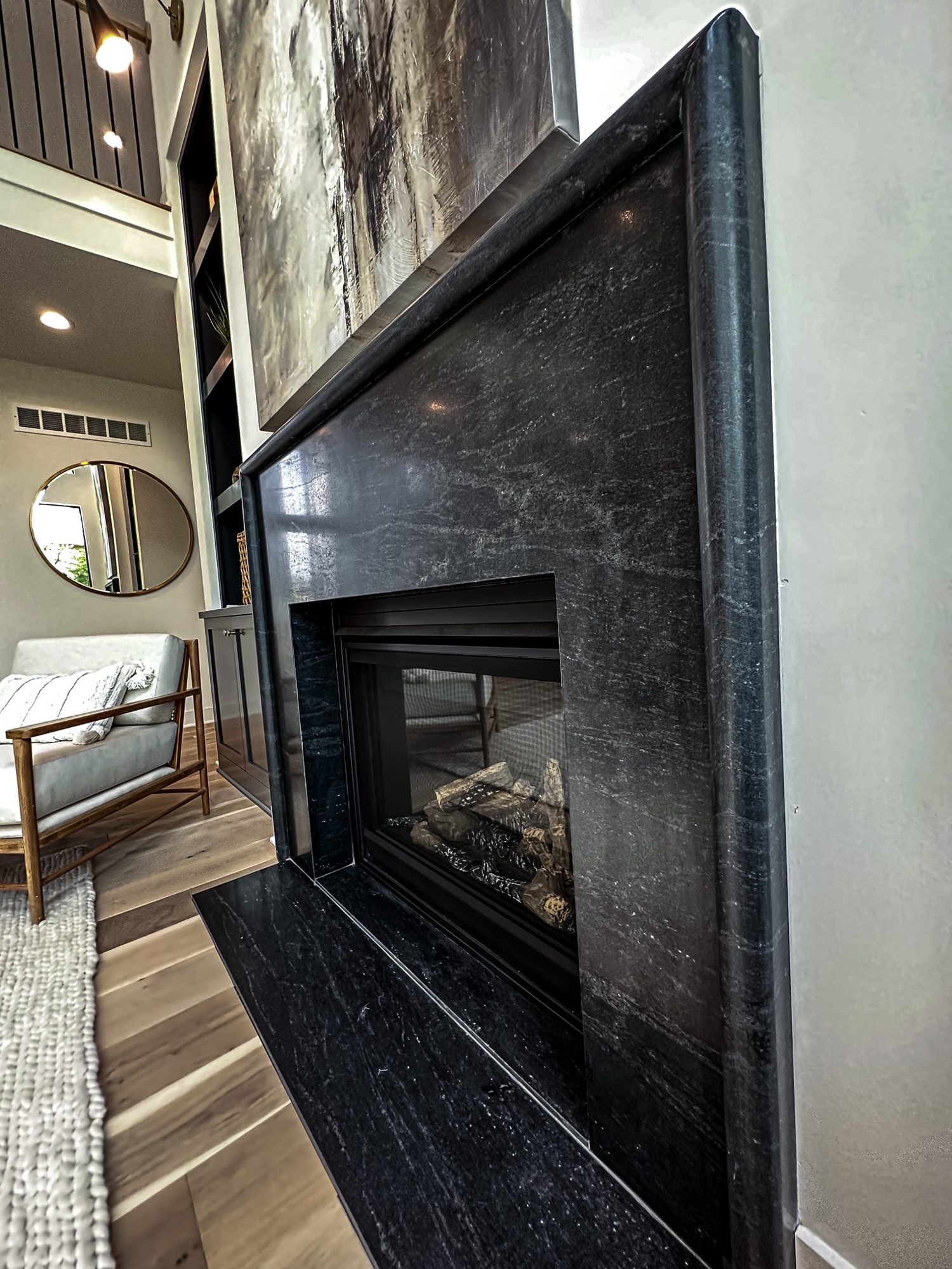 Black stone fireplace surround fabricated by KS Granite House